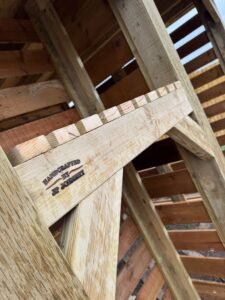 Close-up of handcrafted wooden structure showcasing the craftsmanship of JP Joinery, highlighting the detailed joinery and natural wood finish.